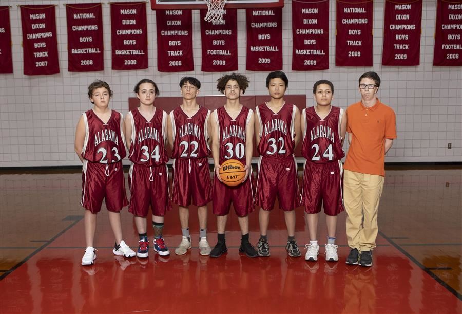 ASD JV Boys basketball team poses for team photo in the gym.